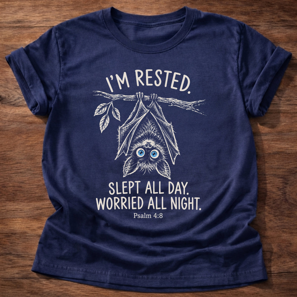 Navy t-shirt printed with an upside-down hanging bat graphic and “I'm rested. Slept all day. Worried all night.” Psalm 4:8 Christian shirt