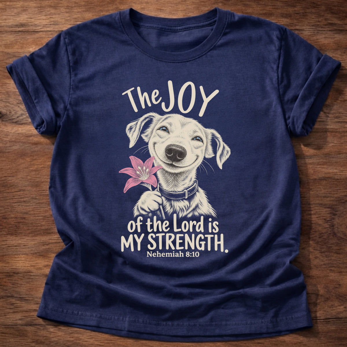 Navy t-shirt printed with a happy smiling pup holding a flower graphic and “The joy of the Lord is my strength.” Nehemiah 8:10 Christian shirt