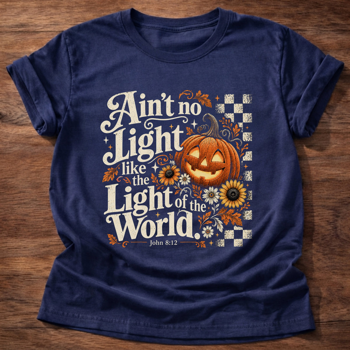 Navy t-shirt printed with a retro glowing jack-o'-lantern with sunflowers and checkerboard graphic and “Ain't no light like the Light of the World.” John 8:12 Christian shirt