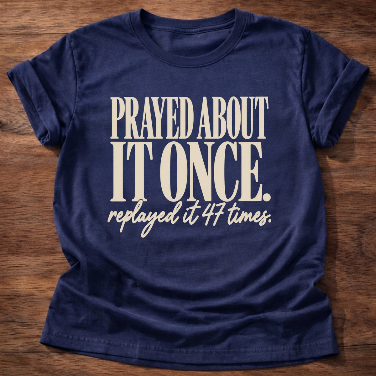 Replayed It Forty-Seven T-Shirt in Navy featuring Prayed About It Once replayed it 47 times funny Christian overthinker typography design with script punchline