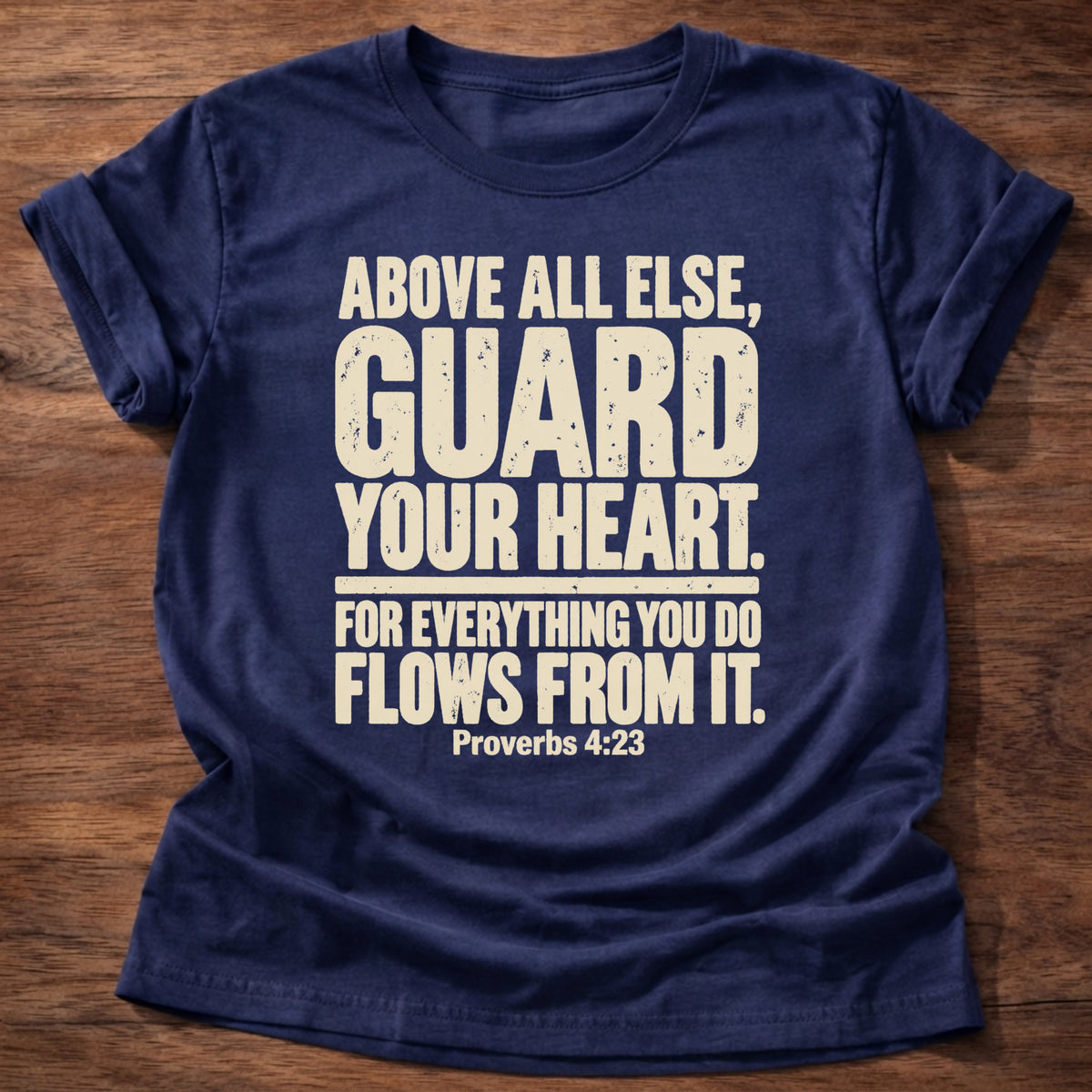 Navy t-shirt printed with bold stacked typography graphic and “Above all else, guard your heart, for everything you do flows from it.” Proverbs 4:23 Christian shirt