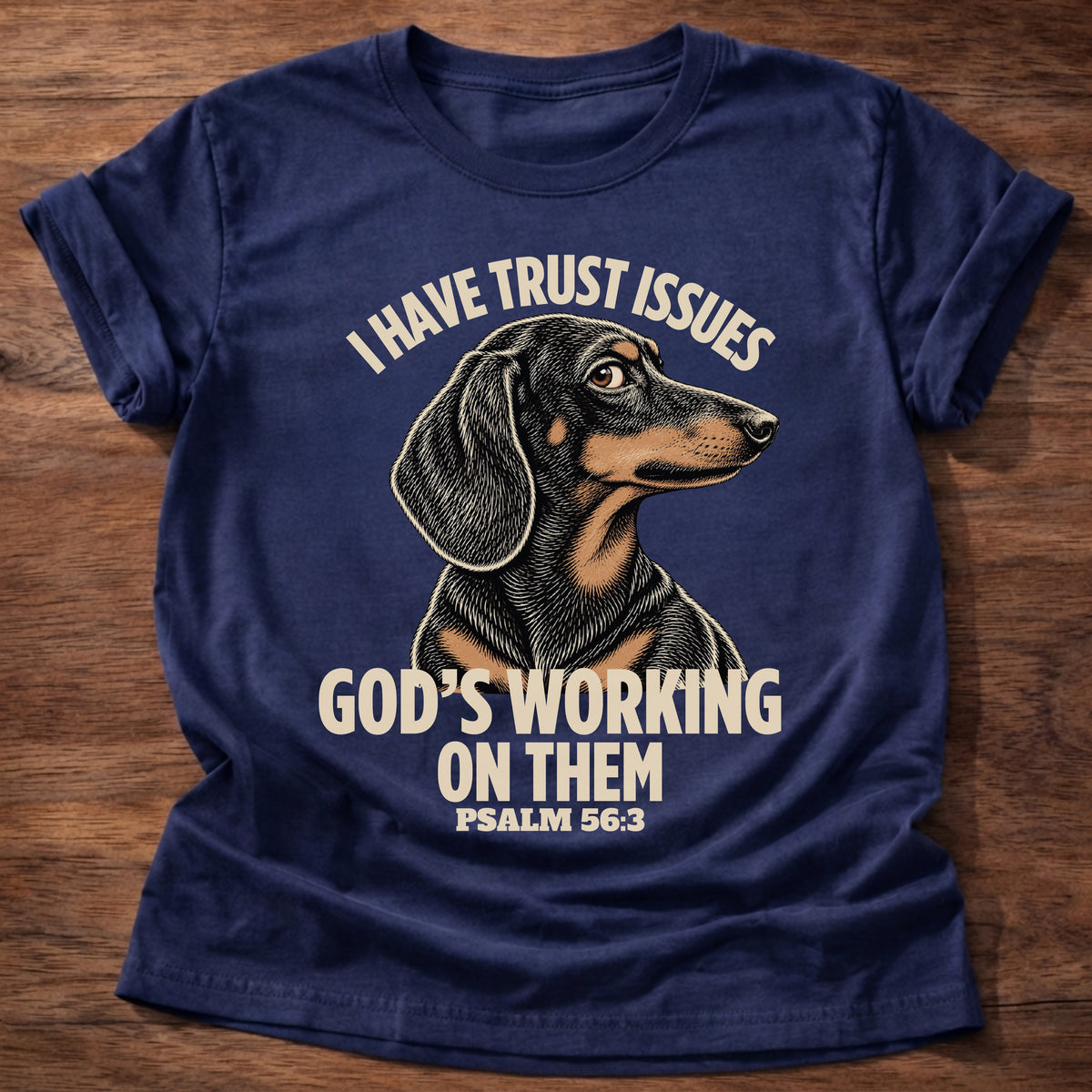 Navy t-shirt printed with a wary dachshund puppy and “I have trust issues. God's working on them.” Psalm 56:3 Christian shirt