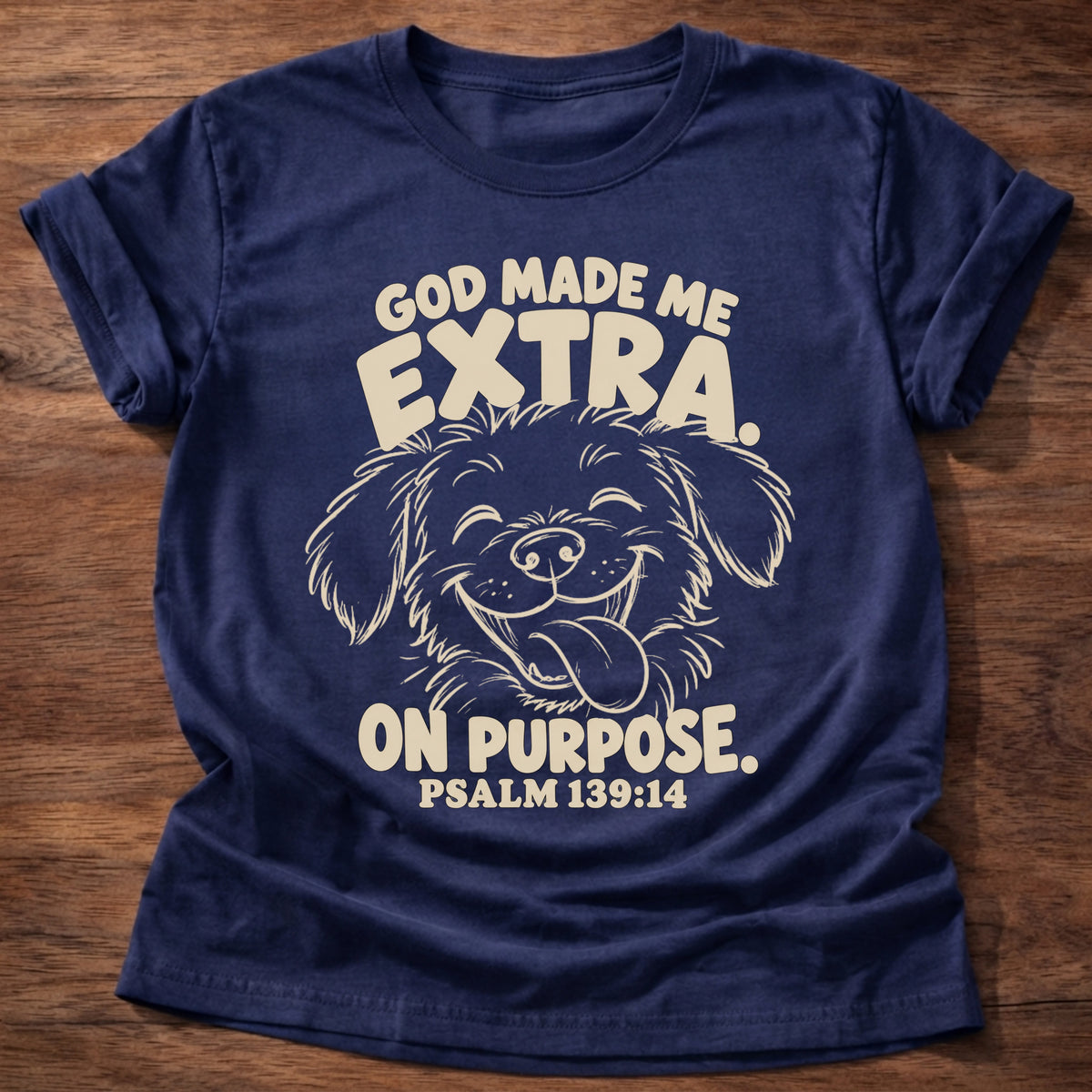 Navy t-shirt printed with a fluffy, happy dog with its tongue out and “God made me extra. On purpose.” Psalm 139:14 Christian shirt