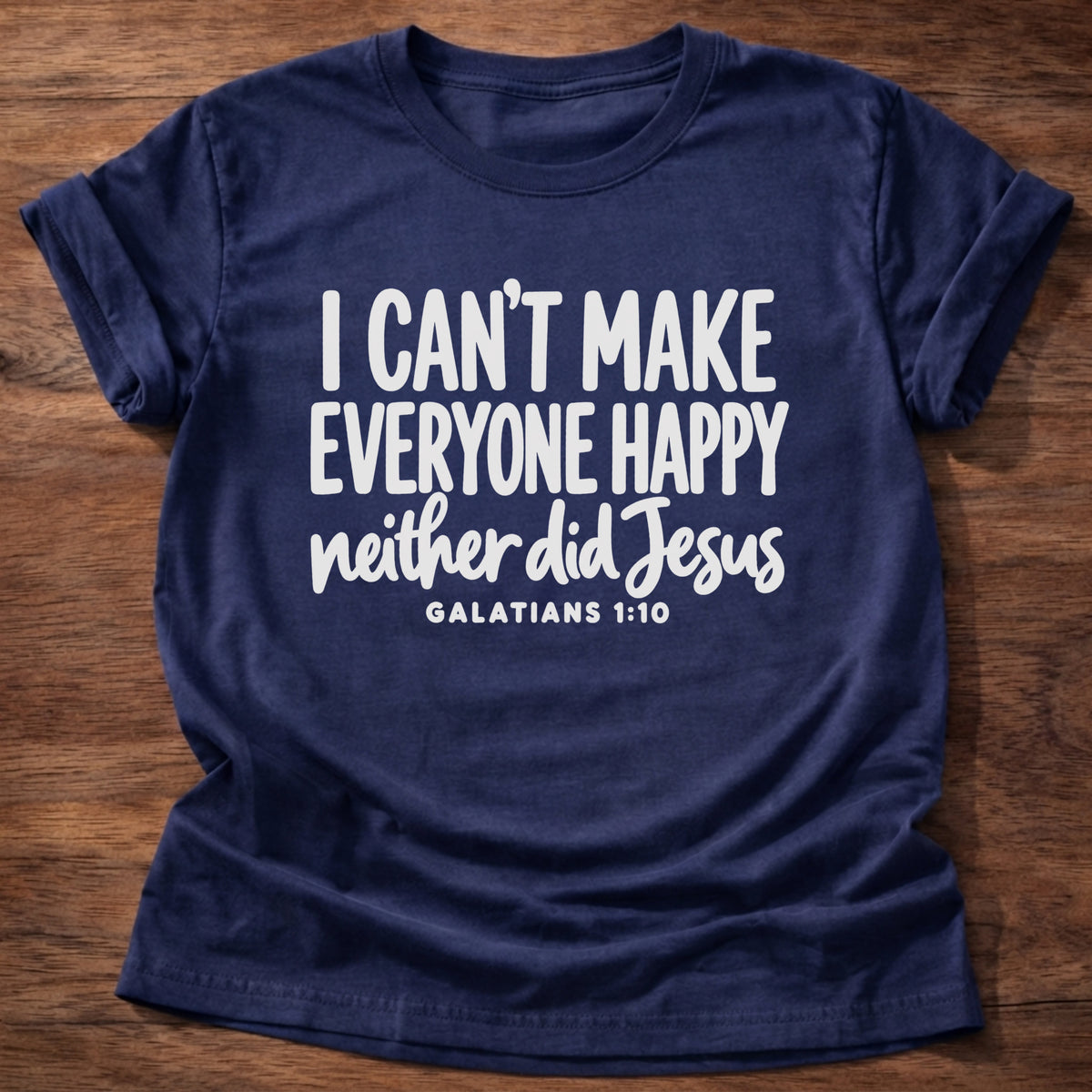 Navy t-shirt printed with bold hand-lettered typography graphic and “I can't make everyone happy. Neither did Jesus.” Galatians 1:10 Christian shirt