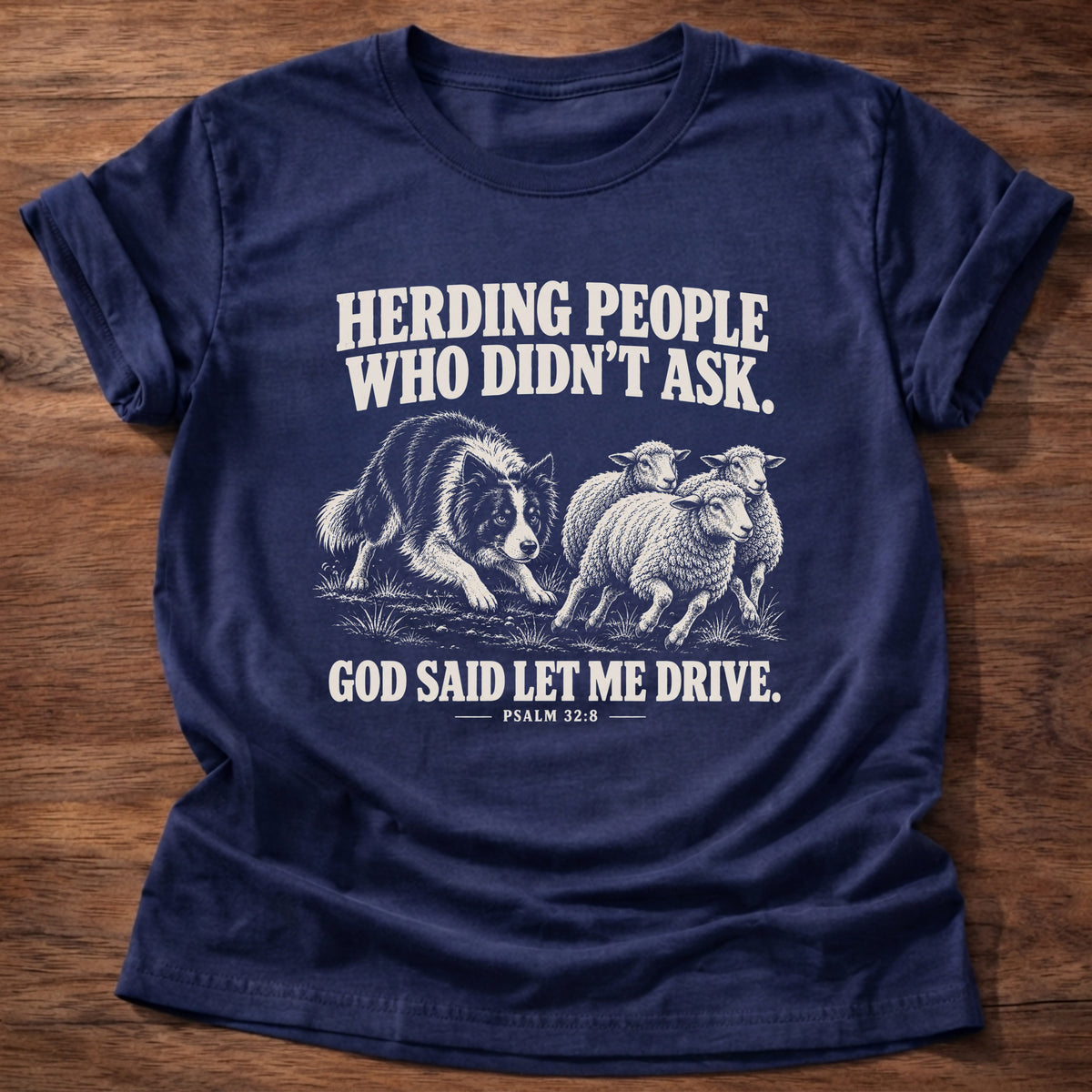Navy t-shirt printed with a border collie herding a flock of sheep graphic and 'Herding people who didn't ask. God said let me drive.' Psalm 32:8 faith based gift