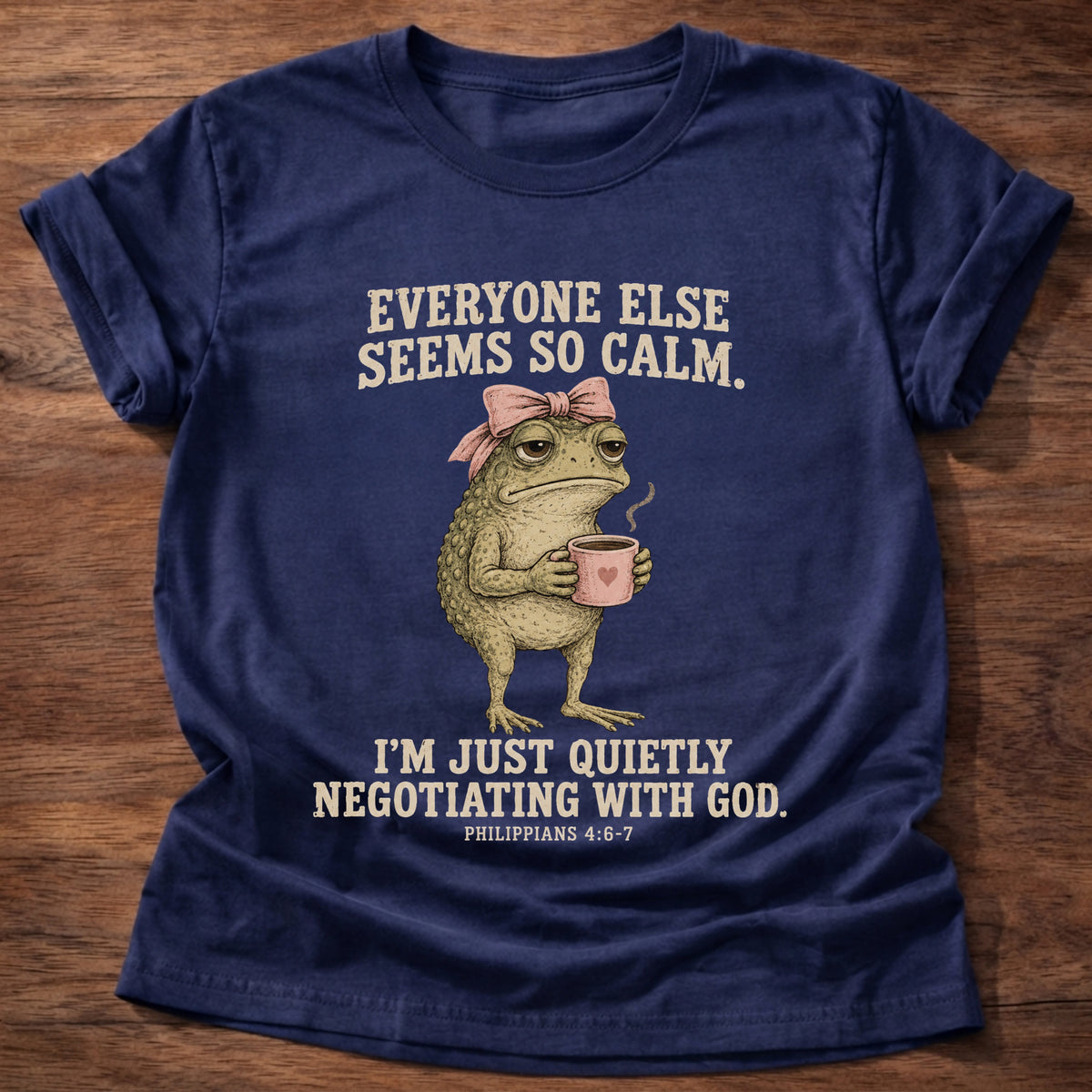 Navy t-shirt printed with a possum holding a tea cup graphic and 'Everyone else seems so calm. I'm just quietly negotiating with God.' Philippians 4:6-7 faith based gift