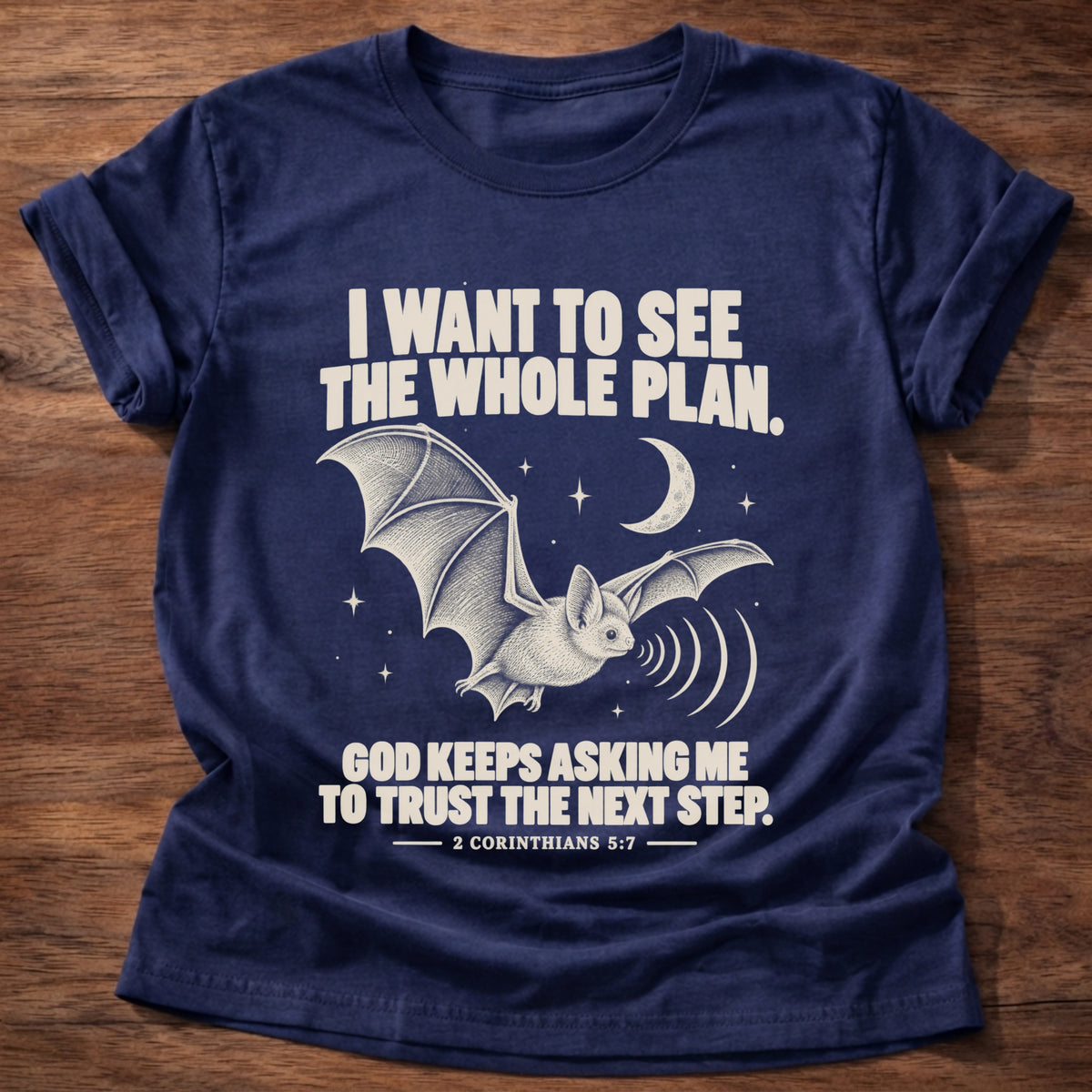 Navy t-shirt printed with a bat flying under a night sky graphic and 'I want to see the whole plan. God keeps asking me to trust the next step.' 2 Corinthians 5:7 faith based gift