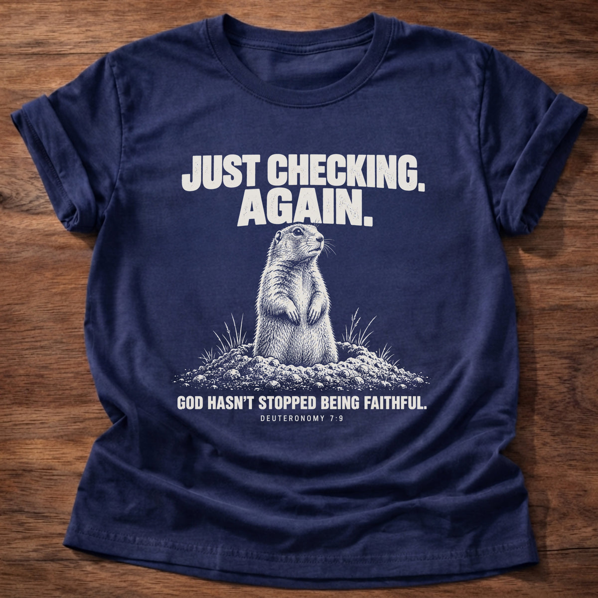 Navy t-shirt printed with a prairie dog popping up out of its burrow graphic and 'Just checking. Again. God hasn't stopped being faithful.' Deuteronomy 7:9 faith based gift
