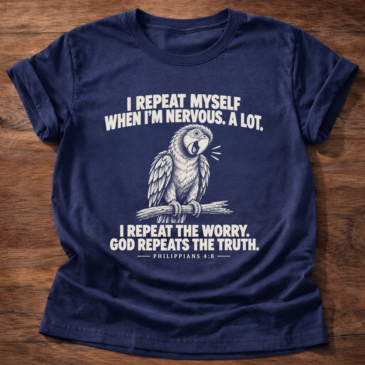 Navy t-shirt printed with a parrot squawking on a perch graphic and 'I repeat myself when I'm nervous. A lot. I repeat the worry. God repeats the truth.' Philippians 4:6 faith based gift