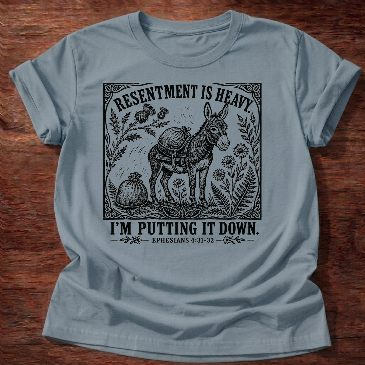 Stone Blue Gildan 64000 t-shirt with a donkey carrying a heavy load illustration and 'Resentment Is Heavy, I'm Putting It Down' text, Ephesians 4:31 Christian t-shirt