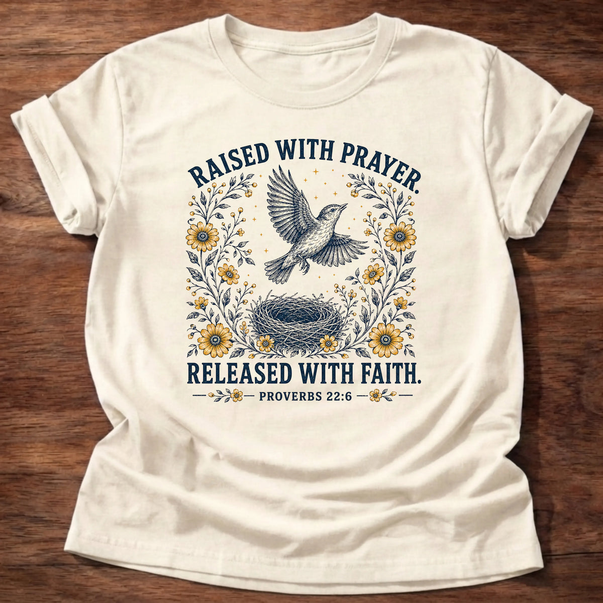 Natural Gildan 64000 t-shirt with a dove, nest, and sunflowers illustration and 'Raised With Prayer, Released With Faith' text, Proverbs 22:6 Christian t-shirt