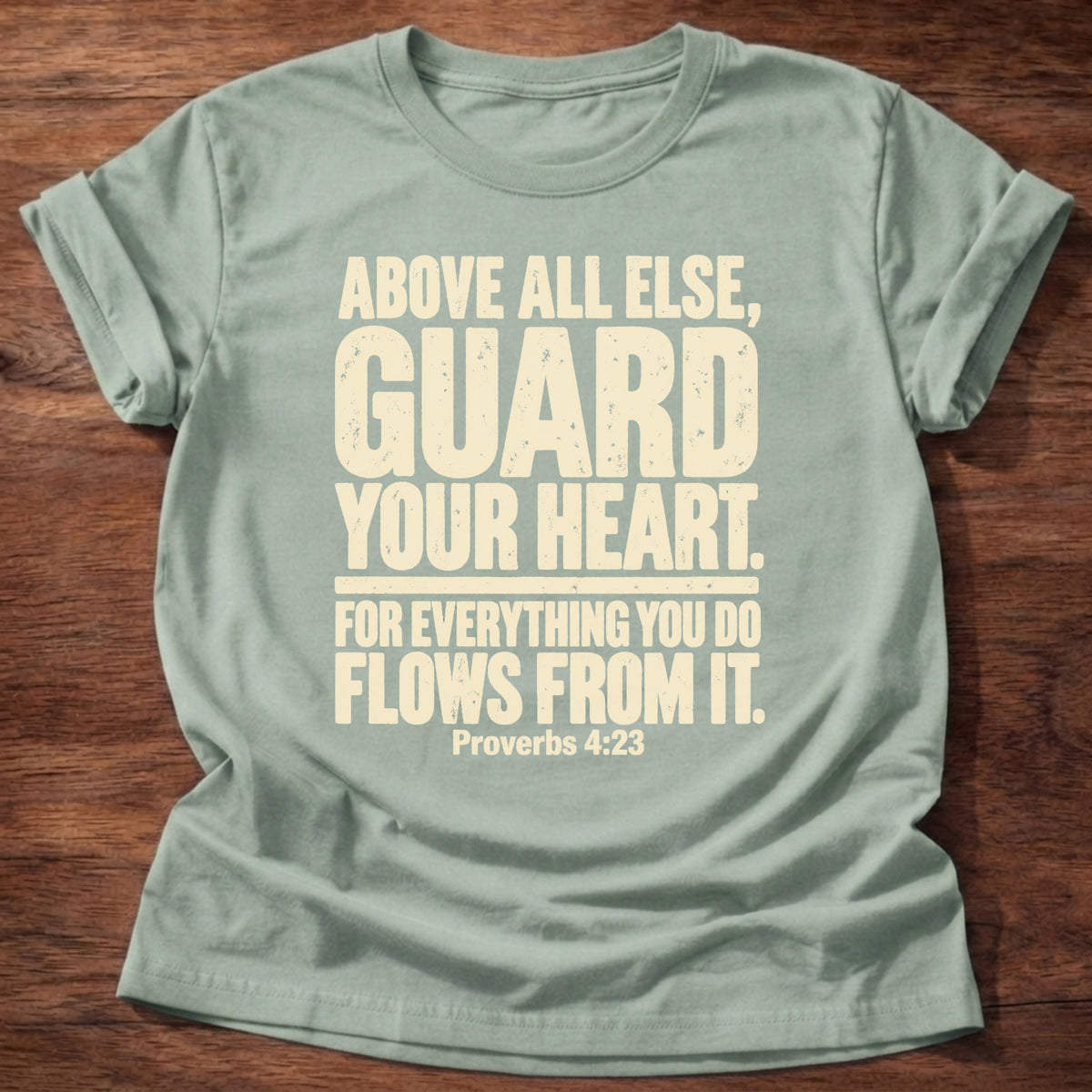 Sage t-shirt printed with bold stacked typography graphic and “Above all else, guard your heart, for everything you do flows from it.” Proverbs 4:23 Christian shirt