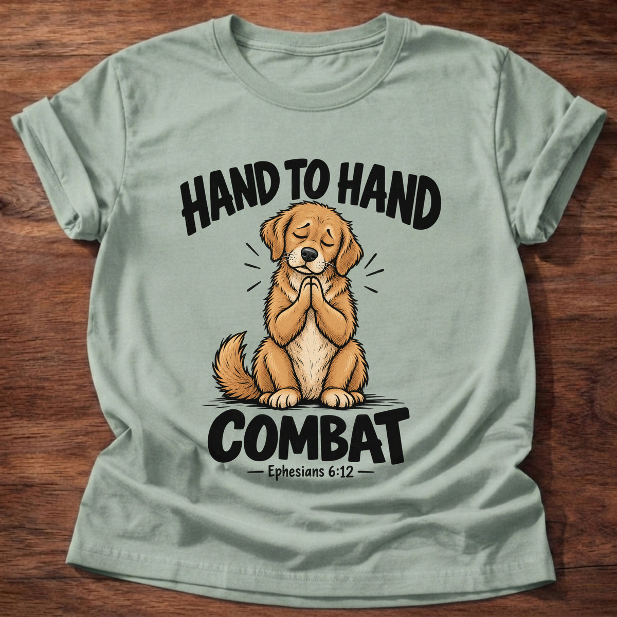 Sage t-shirt printed with a golden retriever puppy with eyes closed and paws folded in prayer graphic and “Hand to hand combat” Ephesians 6:12 faith based gift