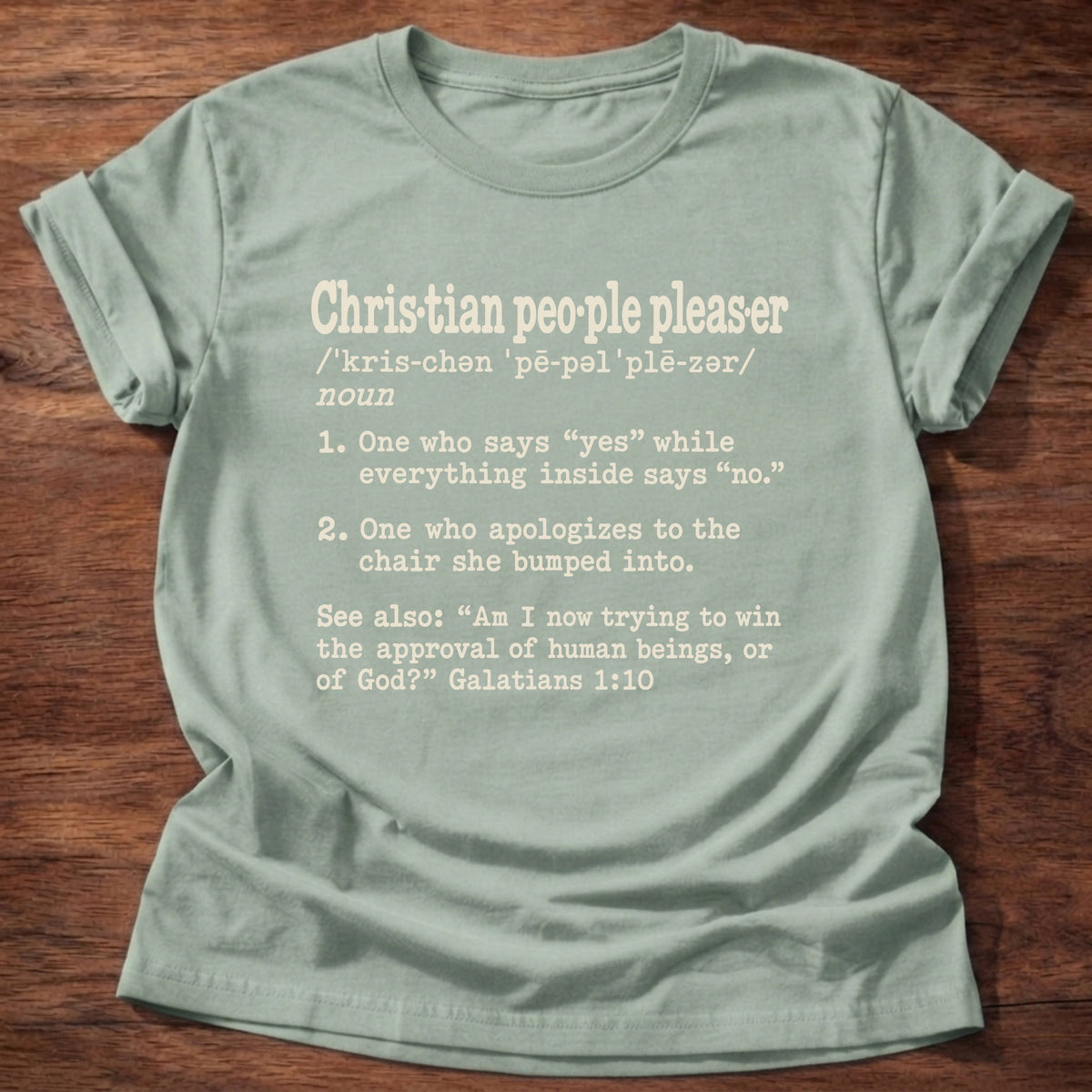 Christian People Pleaser T-Shirt in Sage featuring Christian People Pleaser dictionary definition typewriter design with Galatians 1:10 approval of God