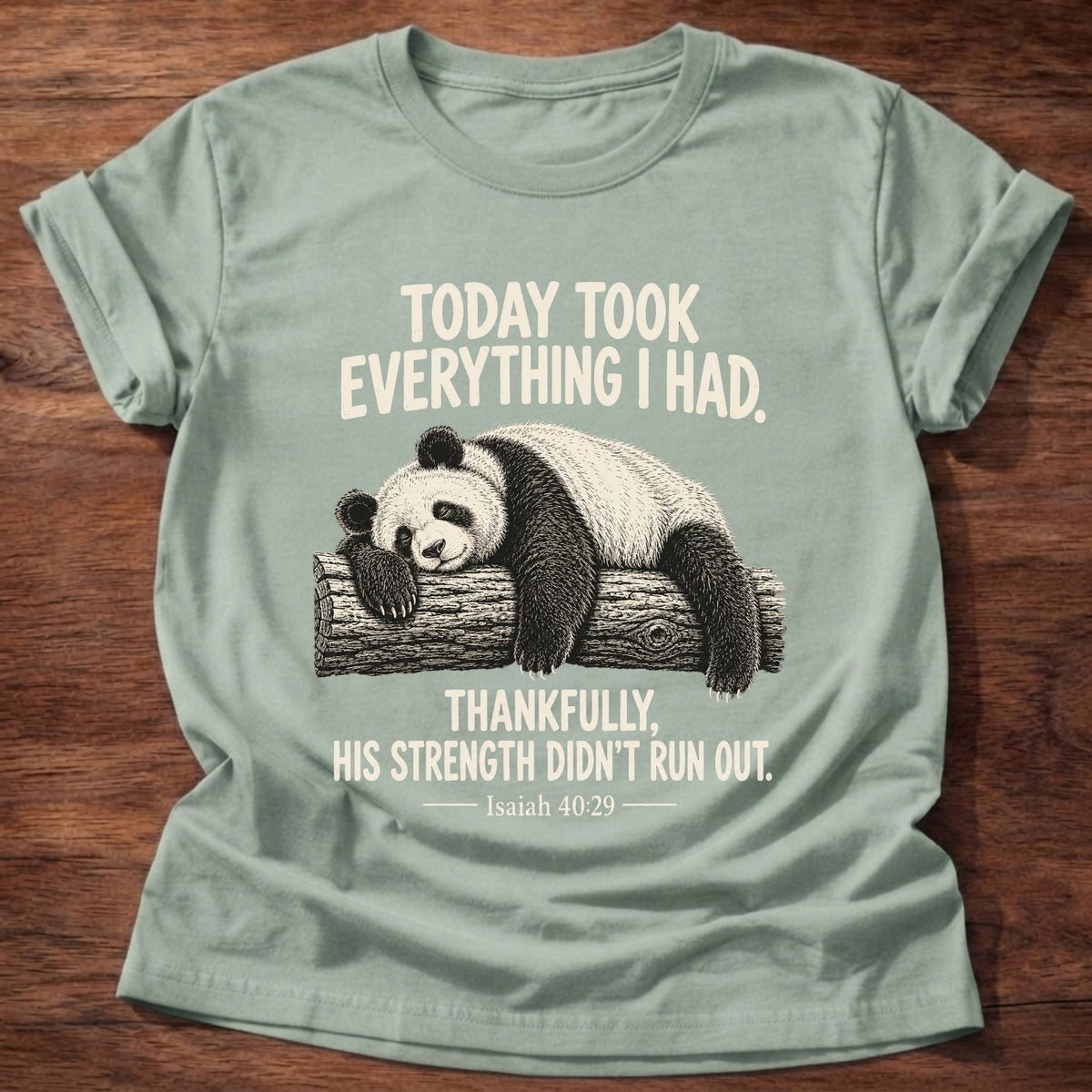 Sage t-shirt printed with a panda sleeping draped over a log graphic and “Today took everything I had. Thankfully, His strength didn't run out.” Isaiah 40:29 faith based gift