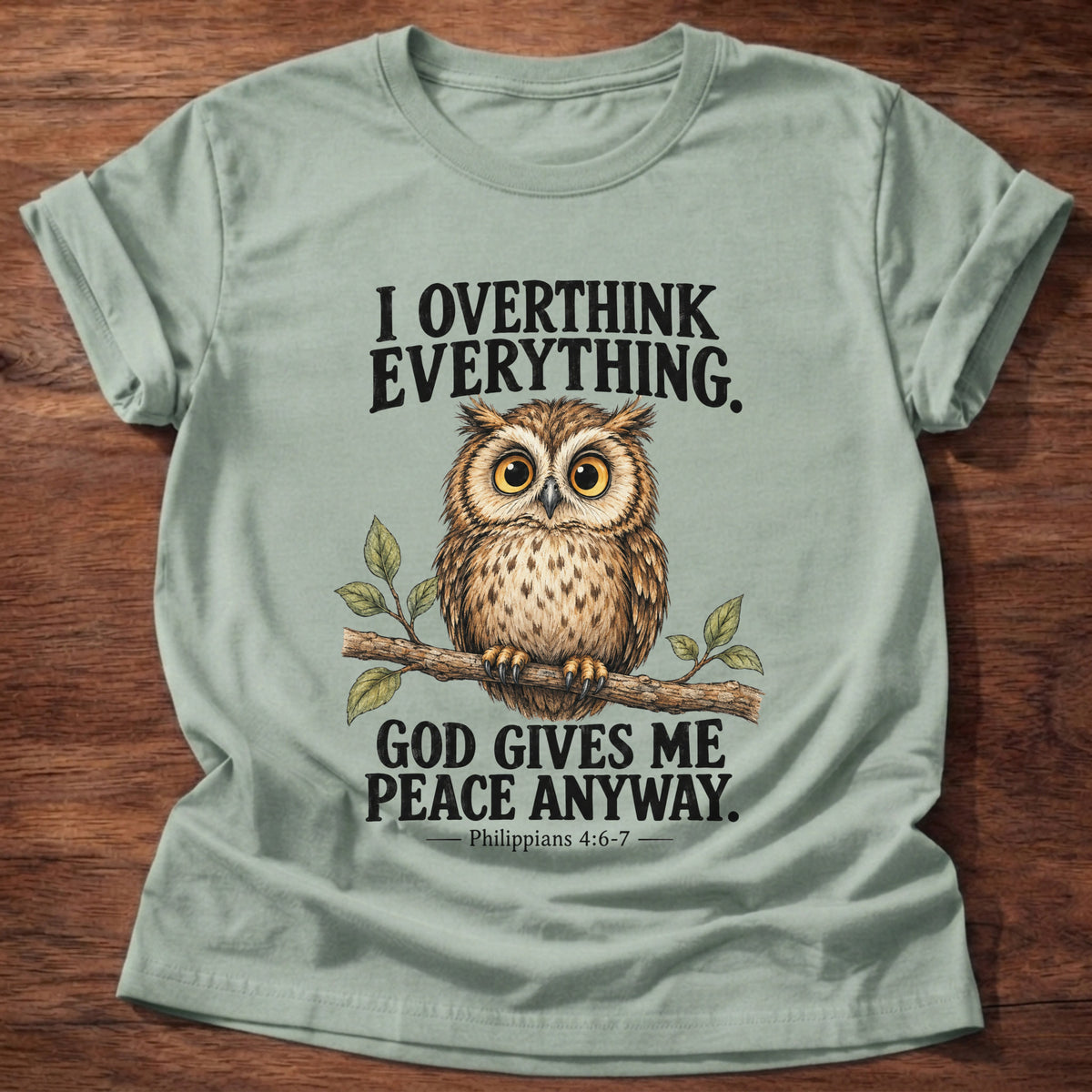 Sage t-shirt printed with a wide-eyed owl perched on a leafy branch graphic and “I overthink everything. God gives me peace anyway.” Philippians 4:6-7 faith based gift