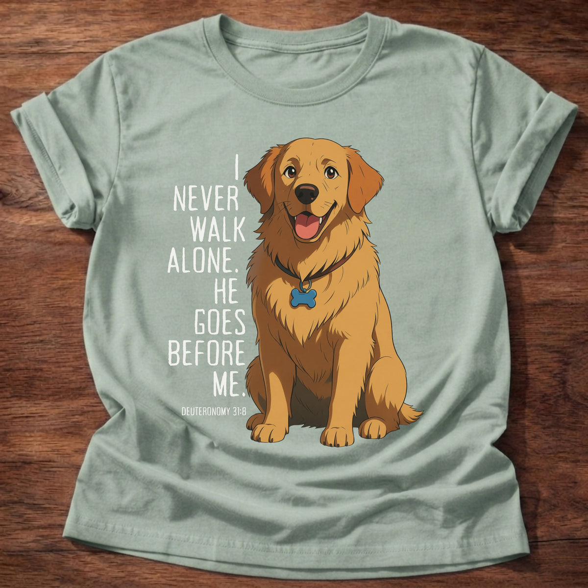 Sage t-shirt printed with a loyal golden retriever graphic and “I never walk alone. He goes before me.” Deuteronomy 31:8 Christian shirt