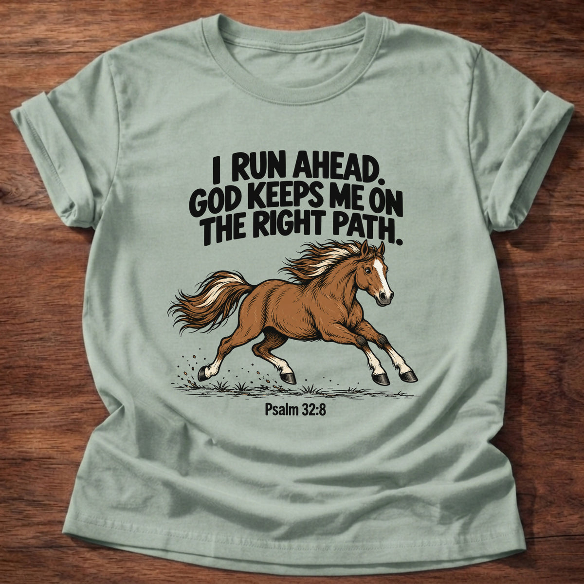 Sage t-shirt printed with a running horse graphic and 'I run ahead. God keeps me on the right path.' Psalm 32:8 faith based gift