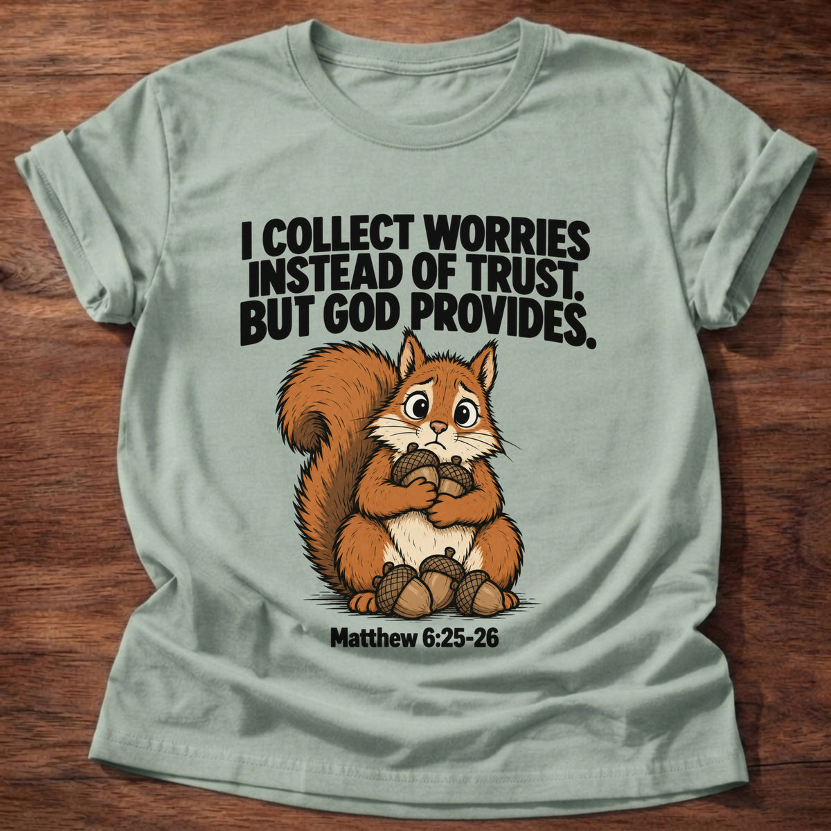 Sage t-shirt printed with a raccoon digging through a bin graphic and 'I dig through things I should just leave to God.' Psalm 121:1-2 faith based gift