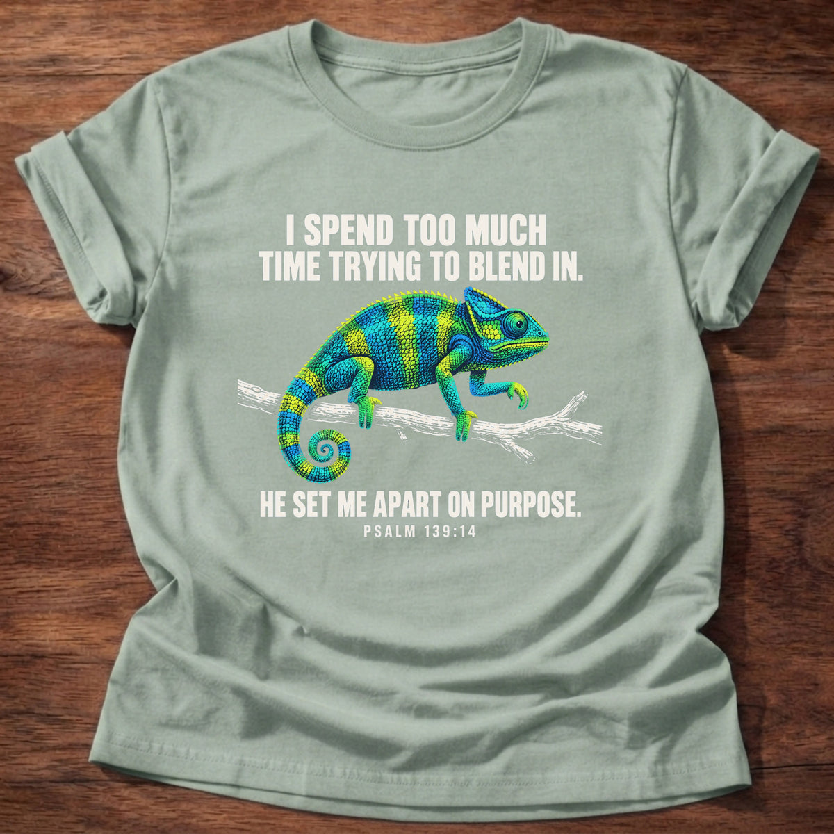 Sage t-shirt printed with a chameleon blending into a branch graphic and 'I spend too much time trying to blend in. He set me apart on purpose.' Psalm 139:14 faith based gift