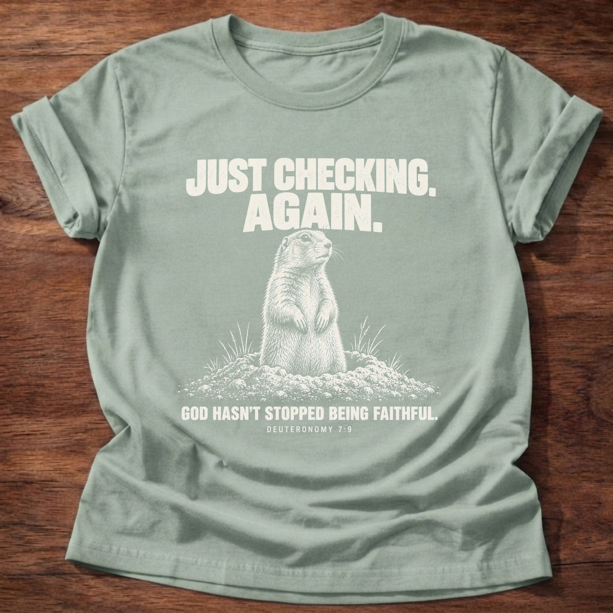 Sage t-shirt printed with a prairie dog popping up out of its burrow graphic and 'Just checking. Again. God hasn't stopped being faithful.' Deuteronomy 7:9 faith based gift