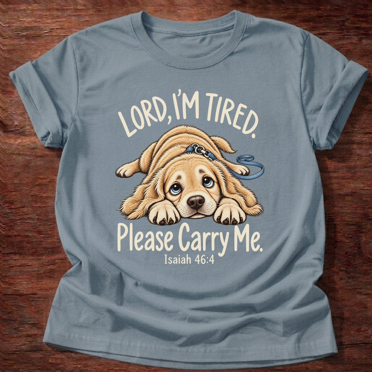 Stone Blue t-shirt printed with a tired puppy lying flat on the floor graphic and “Lord, I'm tired. Please carry me.” Isaiah 46:4 Christian shirt