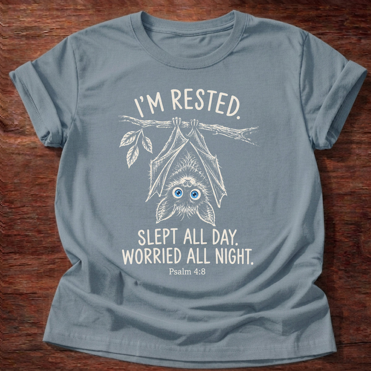 Stone Blue t-shirt printed with an upside-down hanging bat graphic and “I'm rested. Slept all day. Worried all night.” Psalm 4:8 Christian shirt