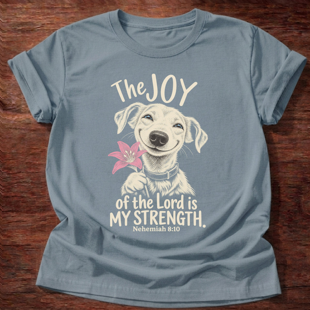 Stone Blue t-shirt printed with a happy smiling pup holding a flower graphic and “The joy of the Lord is my strength.” Nehemiah 8:10 Christian shirt