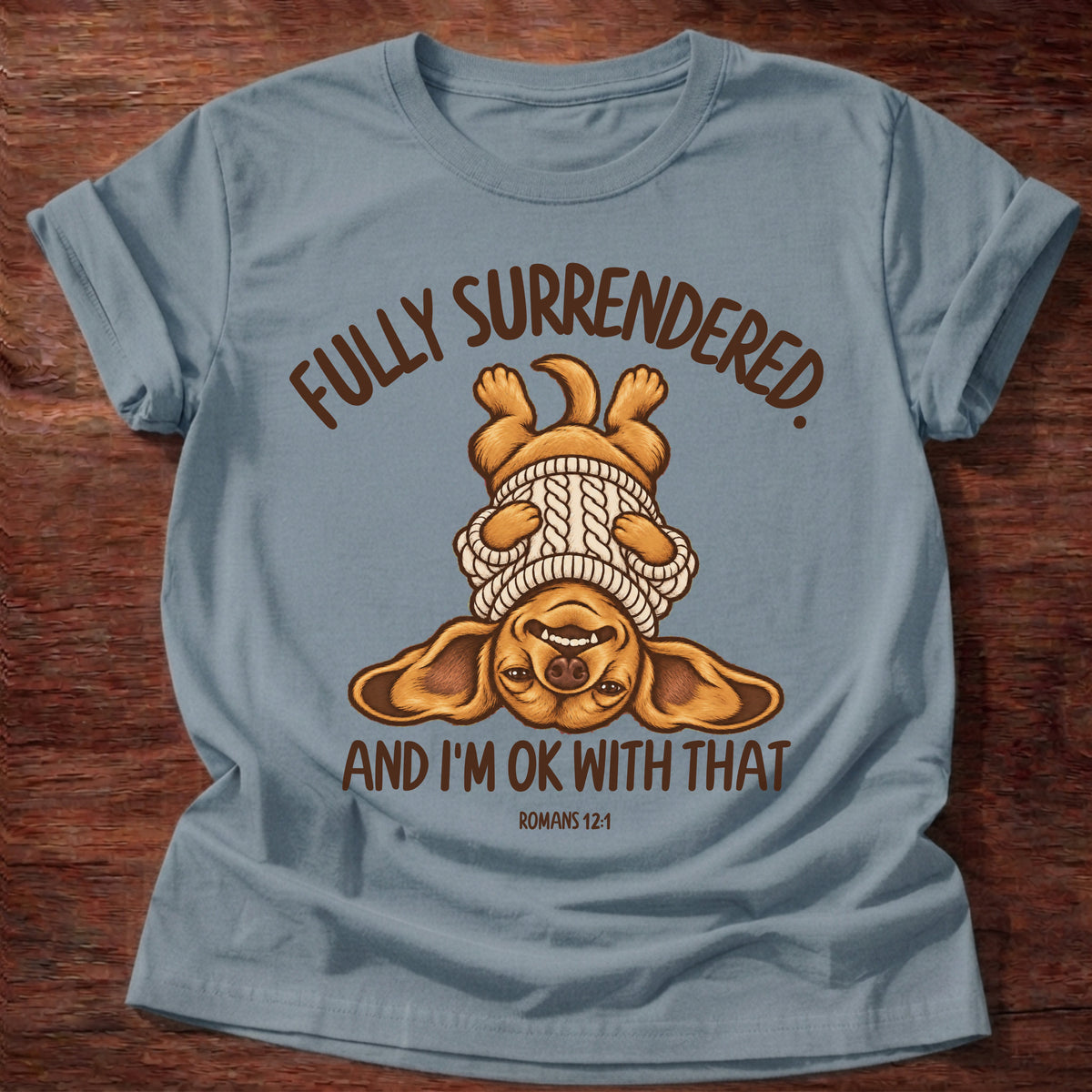 Stone Blue t-shirt printed with an upside-down puppy in a cozy sweater and “Fully surrendered. And I'm OK with that.” Romans 12:1 Christian shirt