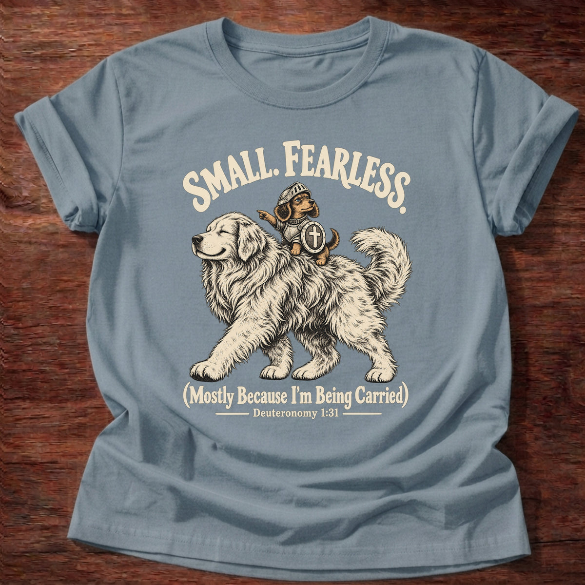 Stone Blue t-shirt printed with a tiny brave rider on a big fluffy dog graphic and “Small. Fearless. (Mostly because I'm being carried.)” Deuteronomy 1:31 Christian shirt