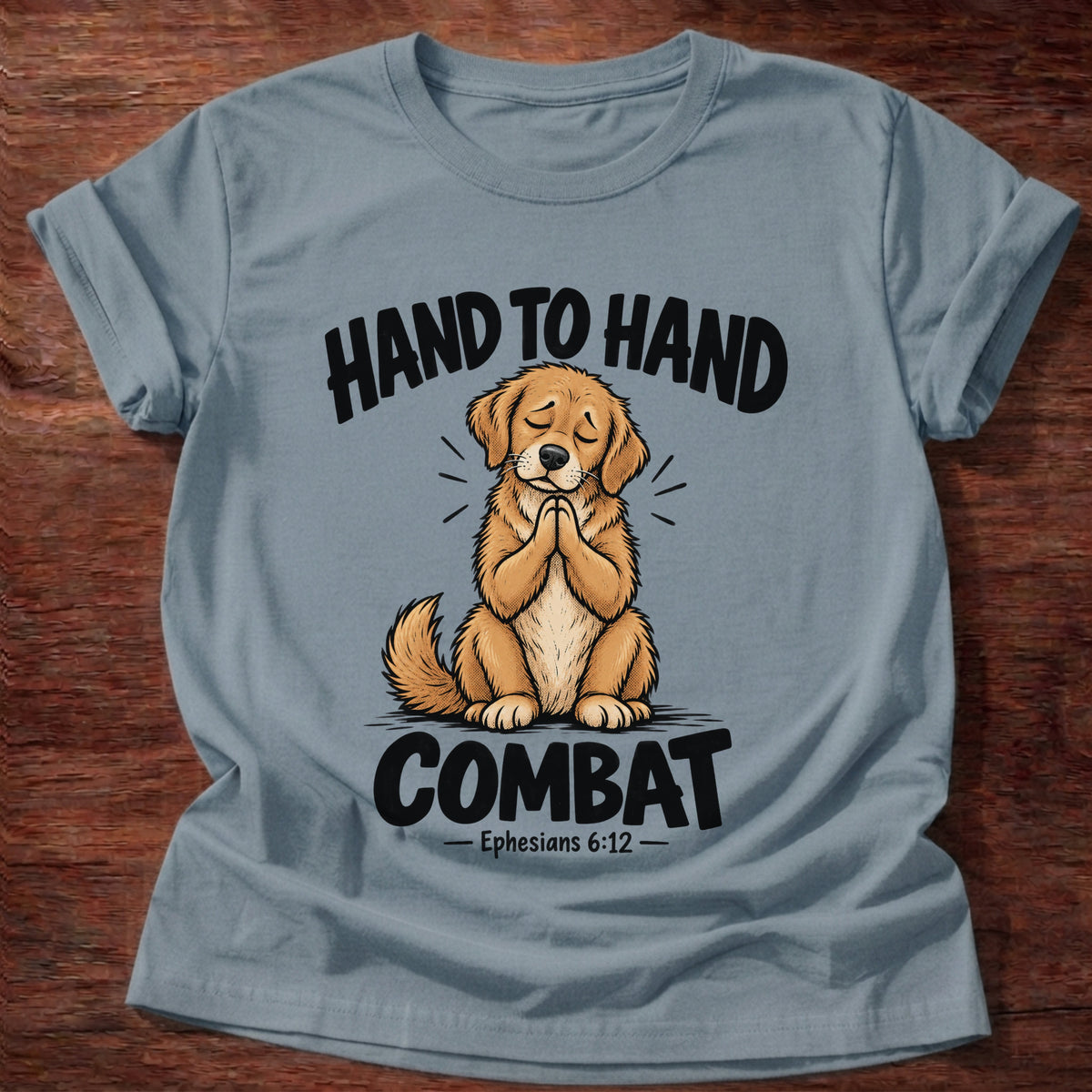 Stone Blue t-shirt printed with a golden retriever puppy with eyes closed and paws folded in prayer graphic and “Hand to hand combat” Ephesians 6:12 faith based gift