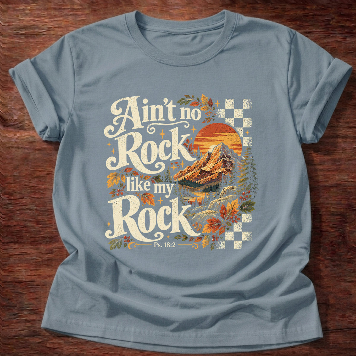 Stone Blue t-shirt printed with a retro mountain sunset with autumn leaves and checkerboard graphic and “Ain't no Rock like my Rock.” Psalm 18:2 Christian shirt