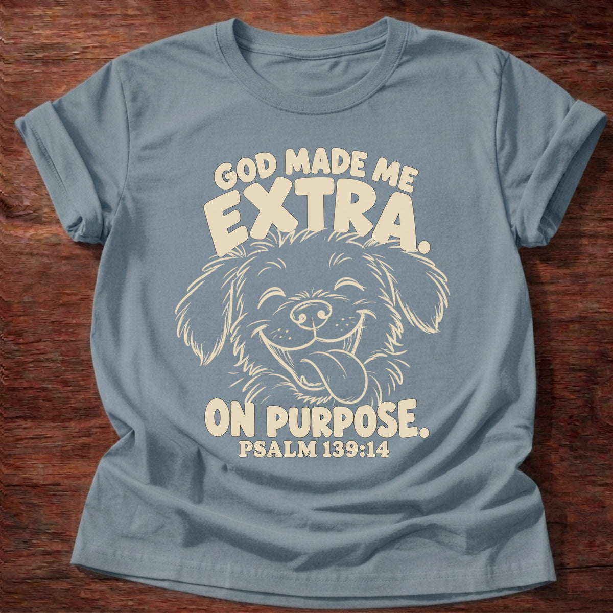 Stone Blue t-shirt printed with a fluffy, happy dog with its tongue out and “God made me extra. On purpose.” Psalm 139:14 Christian shirt