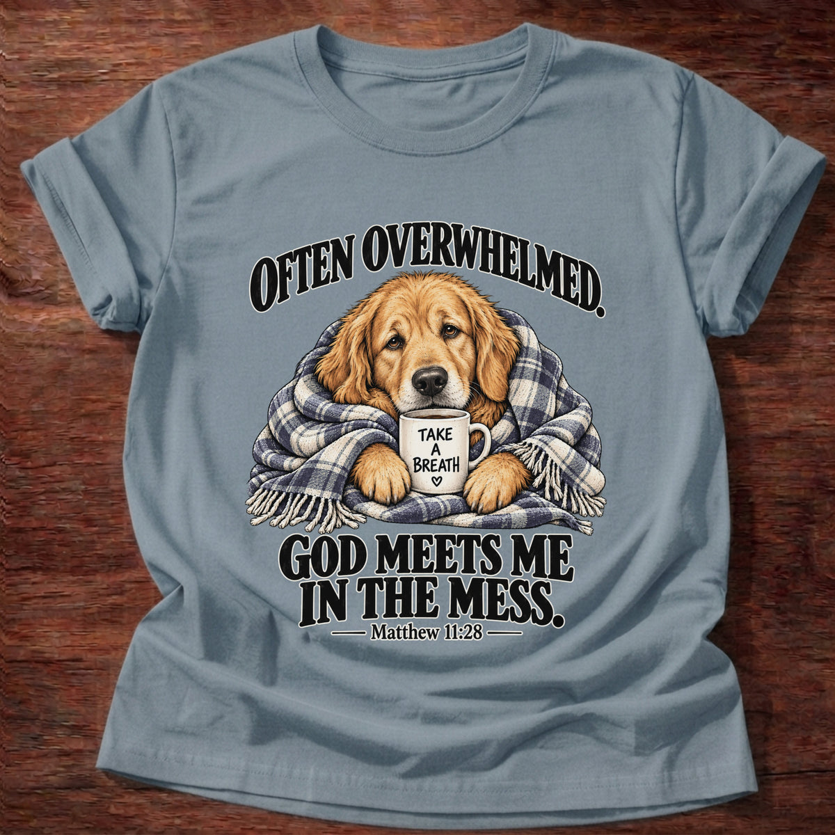 Stone Blue t-shirt printed with a golden retriever wrapped in a plaid blanket holding a 'Take a Breath' mug graphic and “Often overwhelmed. God meets me in the mess.” Matthew 11:28 faith based gift