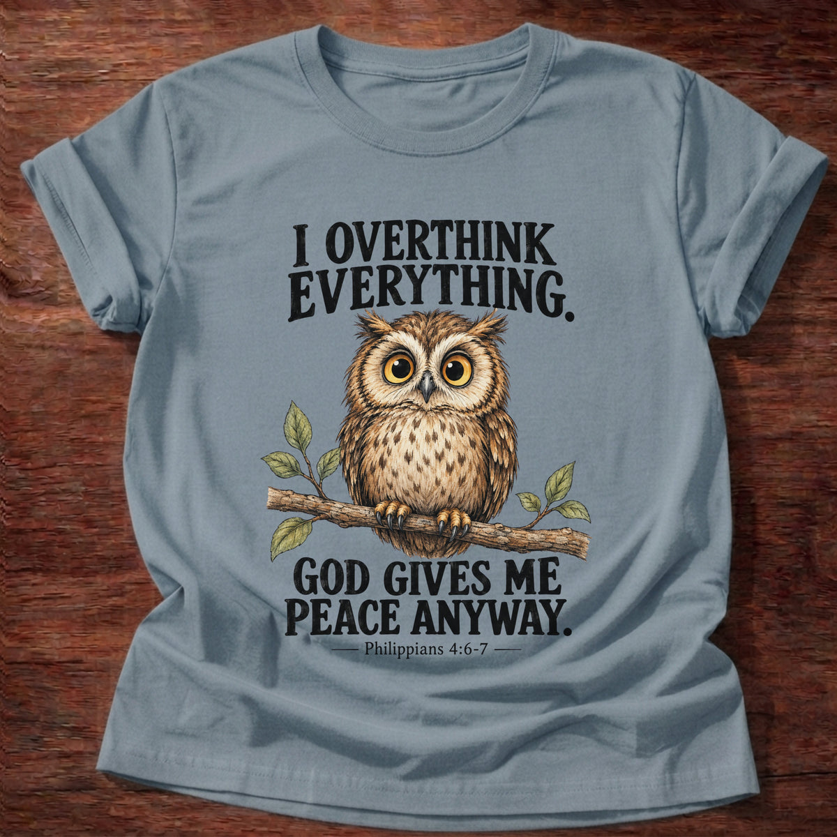 Stone Blue t-shirt printed with a wide-eyed owl perched on a leafy branch graphic and “I overthink everything. God gives me peace anyway.” Philippians 4:6-7 faith based gift
