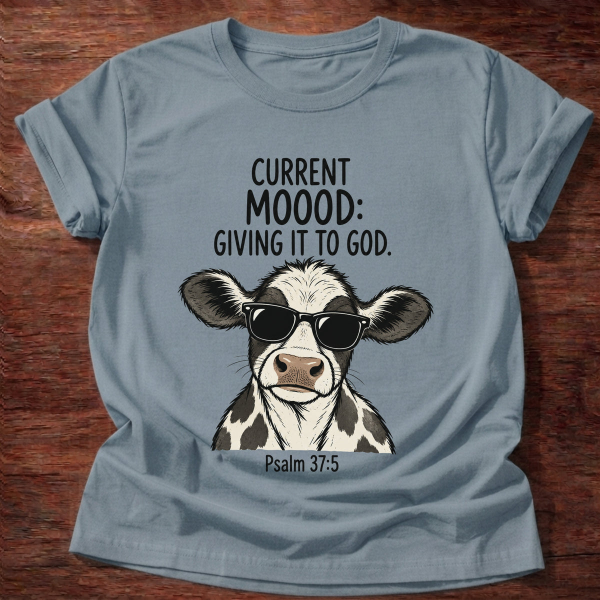 Stone Blue t-shirt printed with a sunglasses-wearing cow graphic and 'Current moood: giving it to God.' Psalm 55:22 faith based gift
