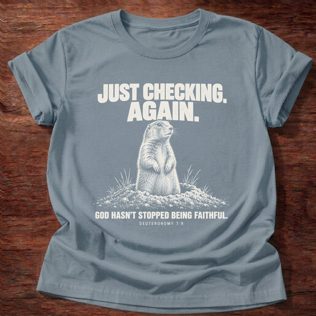 Stone Blue t-shirt printed with a prairie dog popping up out of its burrow graphic and 'Just checking. Again. God hasn't stopped being faithful.' Deuteronomy 7:9 faith based gift