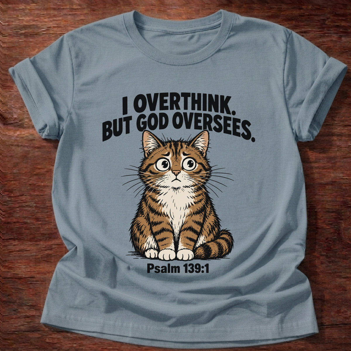 Stone Blue t-shirt printed with a cat graphic and 'I overthink. But God oversees.' Psalm 139:1 faith based gift