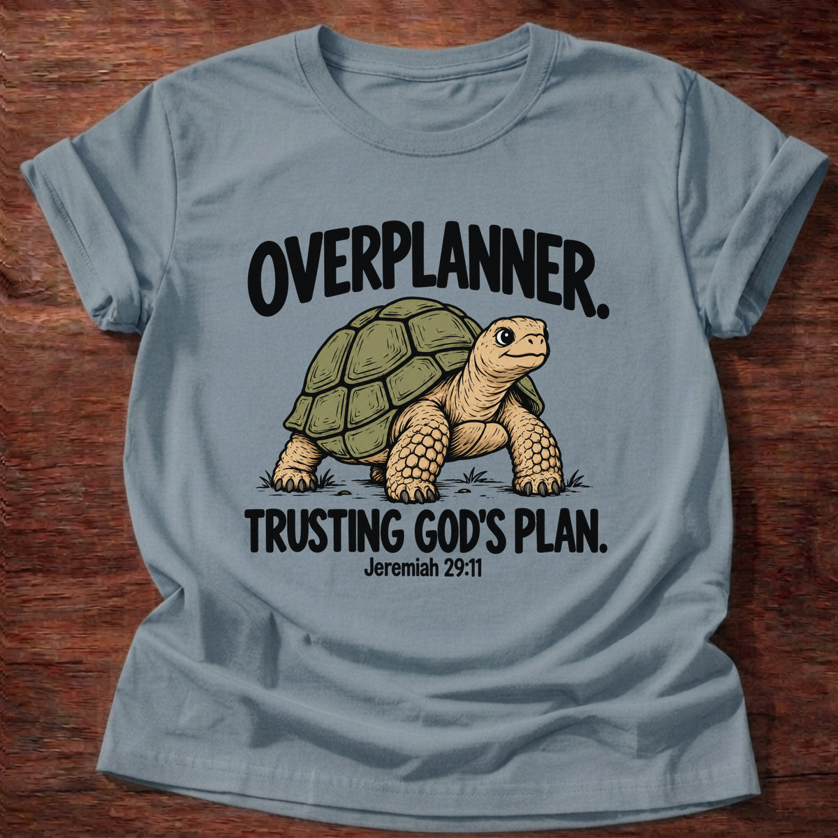 Stone Blue t-shirt printed with a turtle graphic and 'Overplanner. Trusting God's plan.' Jeremiah 29:11 faith based gift