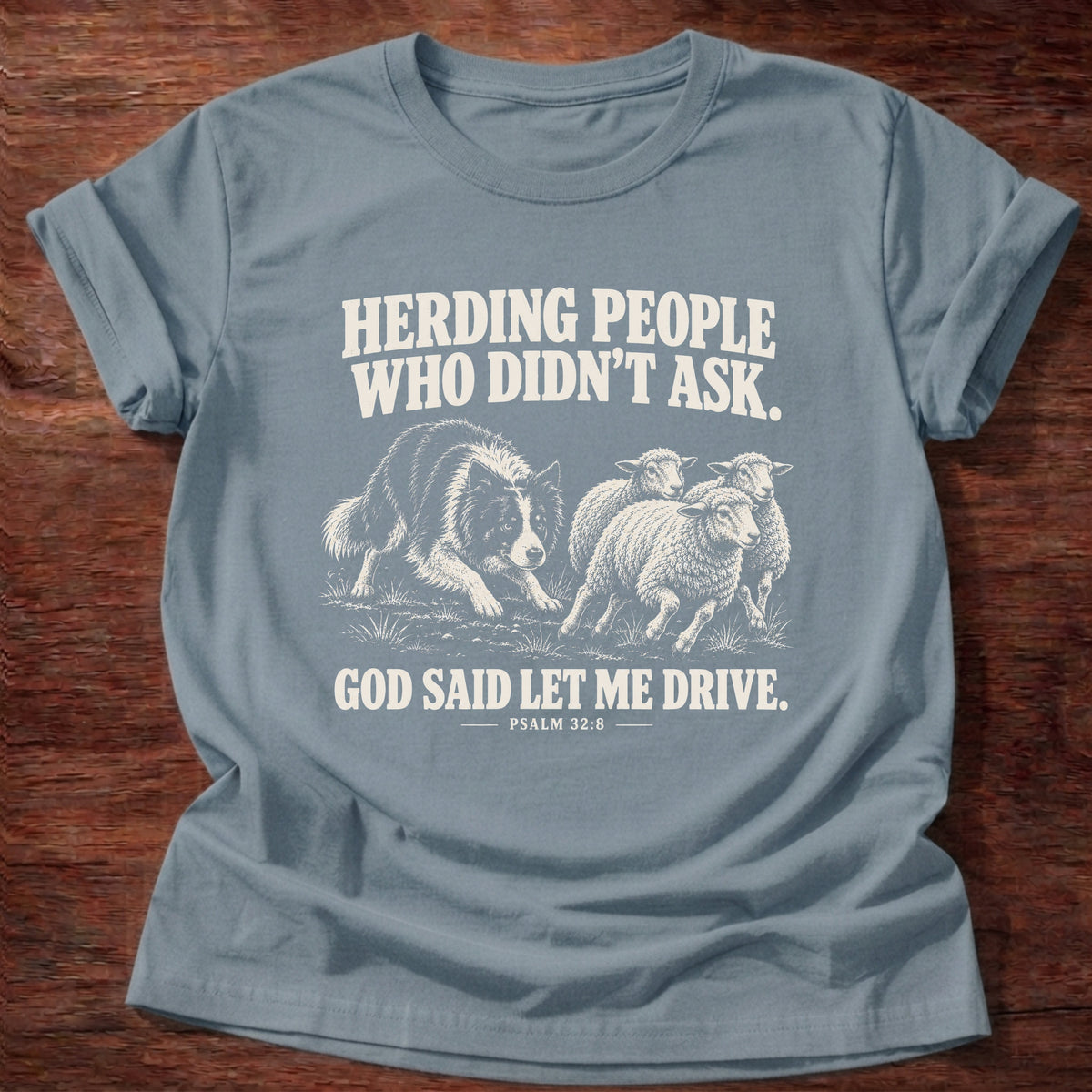 Stone Blue t-shirt printed with a border collie herding a flock of sheep graphic and 'Herding people who didn't ask. God said let me drive.' Psalm 32:8 faith based gift