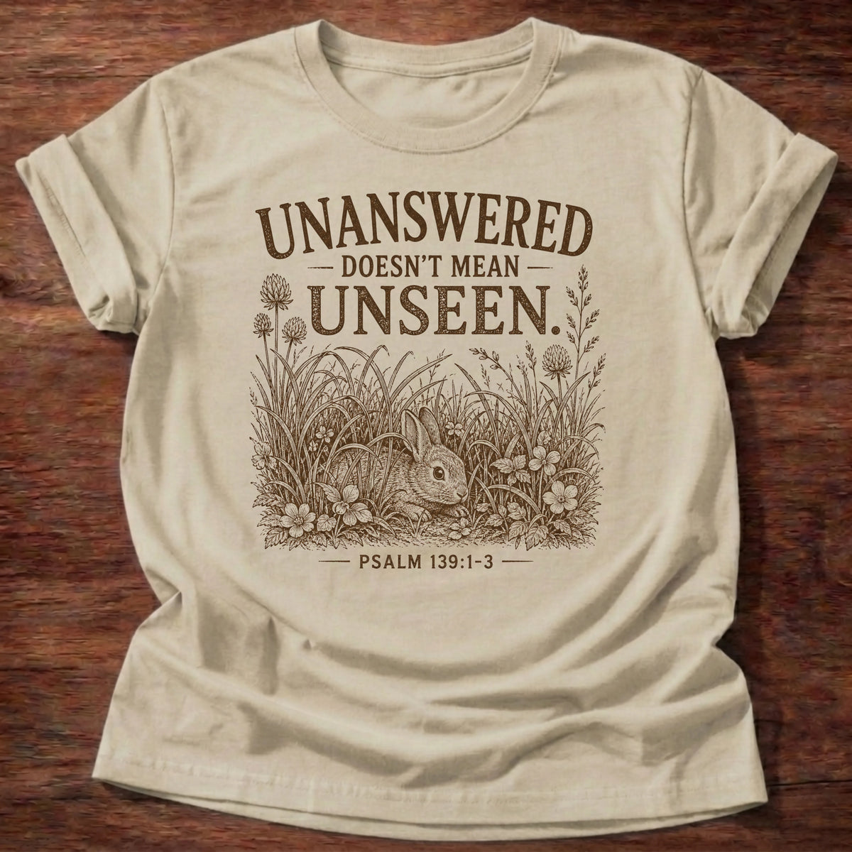 Sand colored t-shirt printed with 'Unanswered doesn't mean unseen' rabbit graphic, faith based gift for unanswered prayer