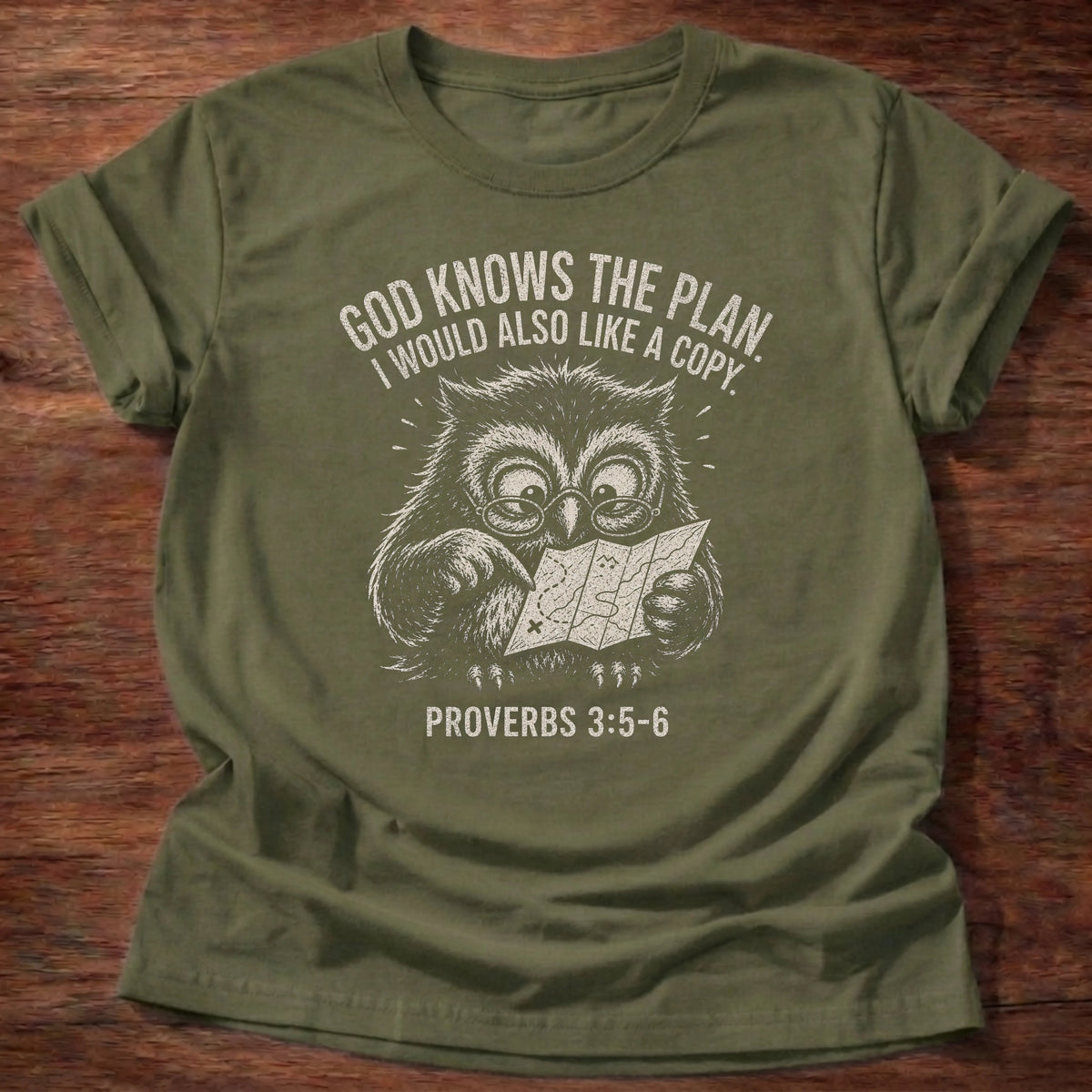 Military green t-shirt with owl illustration reading 'God knows the plan. I would also love a copy.' Christian humor shirt